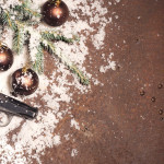 Pistol,And,Christmas,Balls,On,Rustic,Metal,Background.